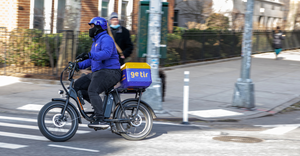 A Getir instant food delivery employee rides a bike near Washington Square Park.png